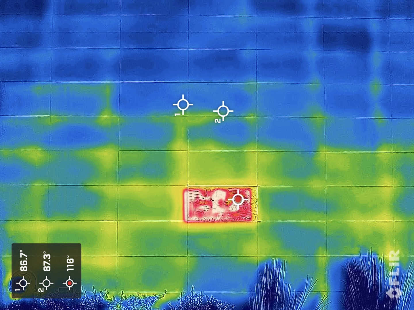 FLIR thermal infrared image of hotel exterior wall revealing inferior mortar coverage through heat signature patterns